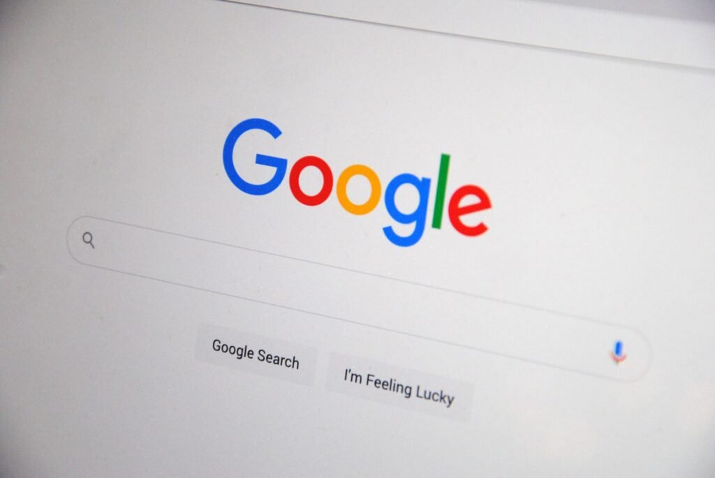 Close-up of the Google homepage on a screen showing search options. référencement SEO